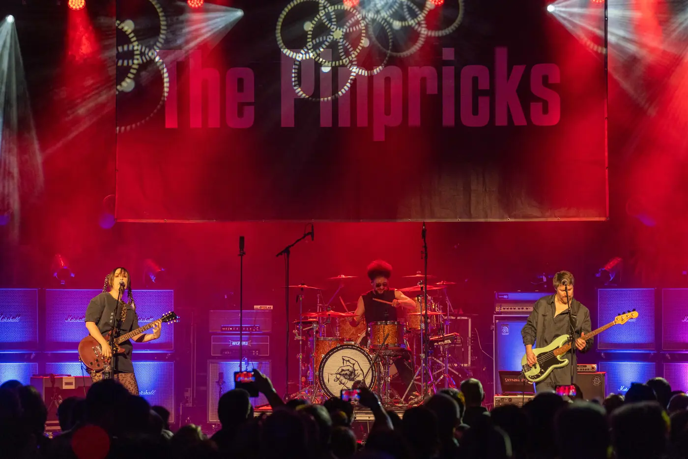 The Pinpricks live on stage under red light